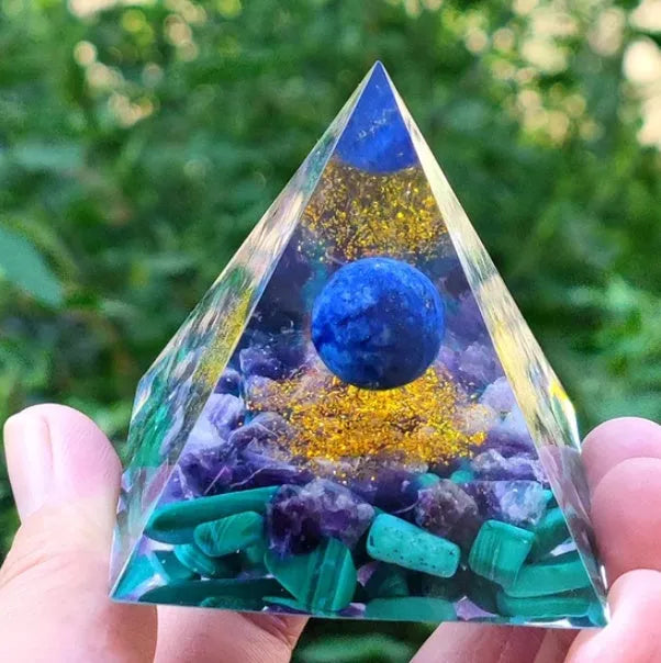 Clear epoxy resin pyramid ornament with embedded coloured crystal gravel inside, measuring 6cm.