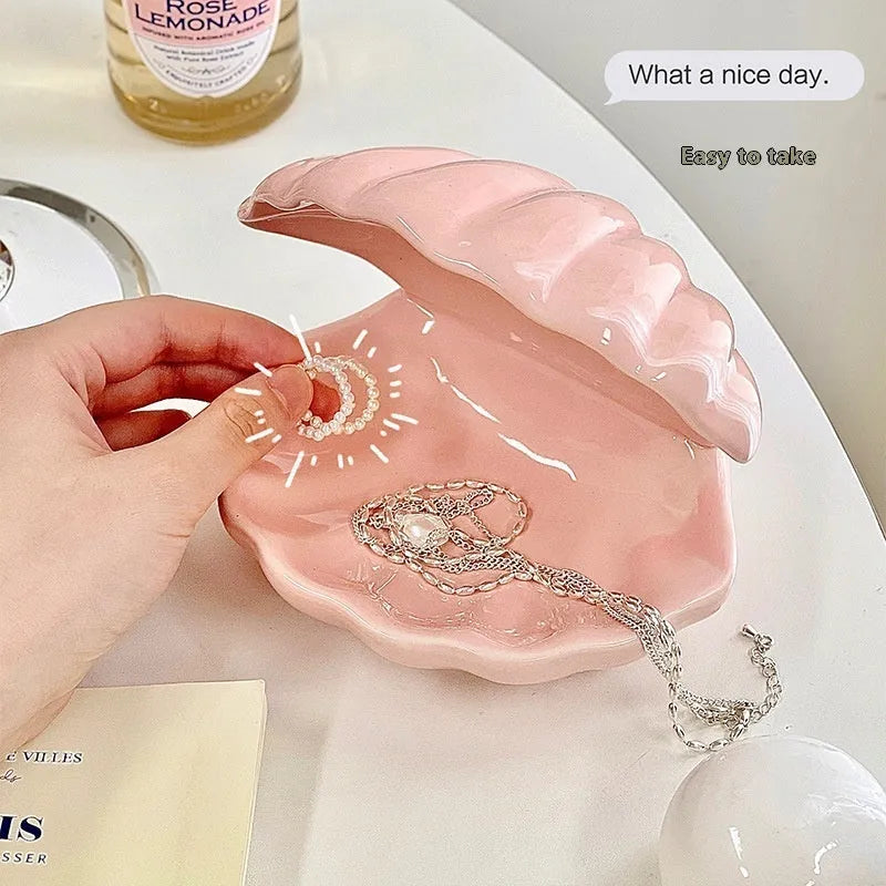 Yellow ceramic ornament tray with a small pink-shell night light placed on it, modern simple style.