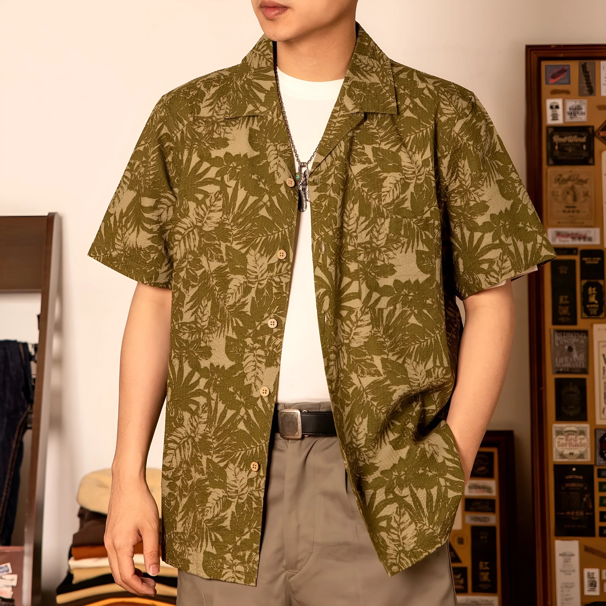 Man wearing a green vintage floral print seersucker shirt with a Cuban collar.