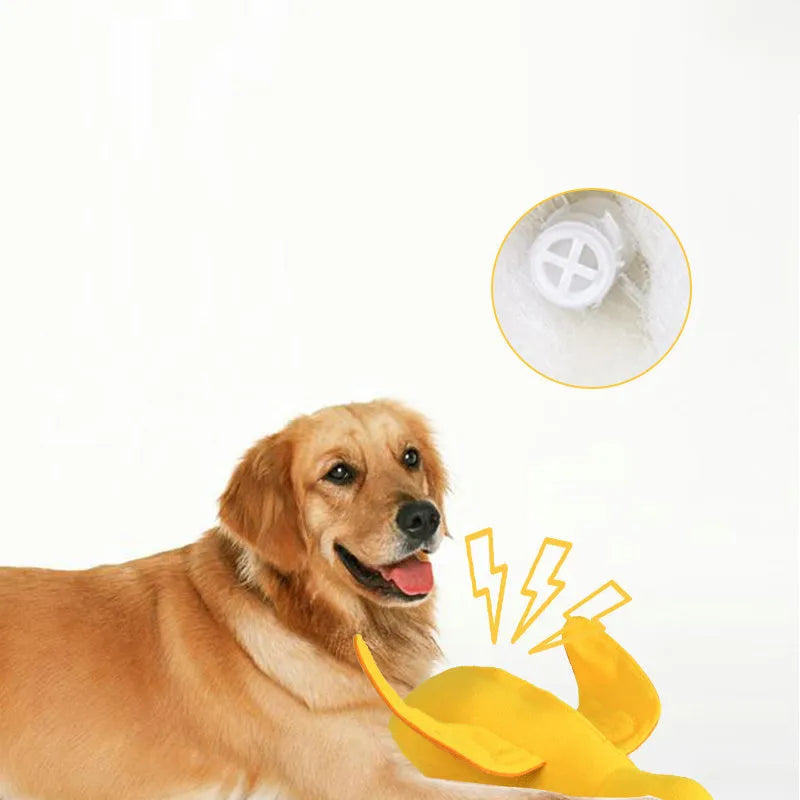 Yellow plush teddy bear dog toy with a small duck doll attached, showing food dispensing holes.
