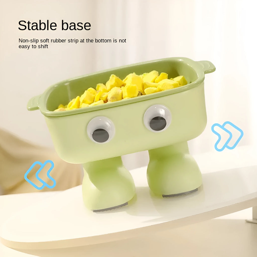 Green robot-shaped elevated cat bowl with tilted food dish and non-slip base.