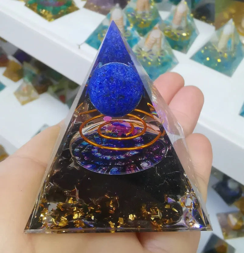 Clear epoxy resin pyramid ornament with embedded coloured crystal gravel inside, measuring 6cm.