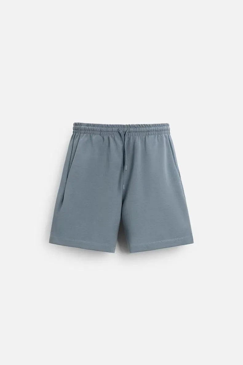 Loose blue polyester T-shirt and matching shorts set on a hanger, showing round neck and double-sided texture.