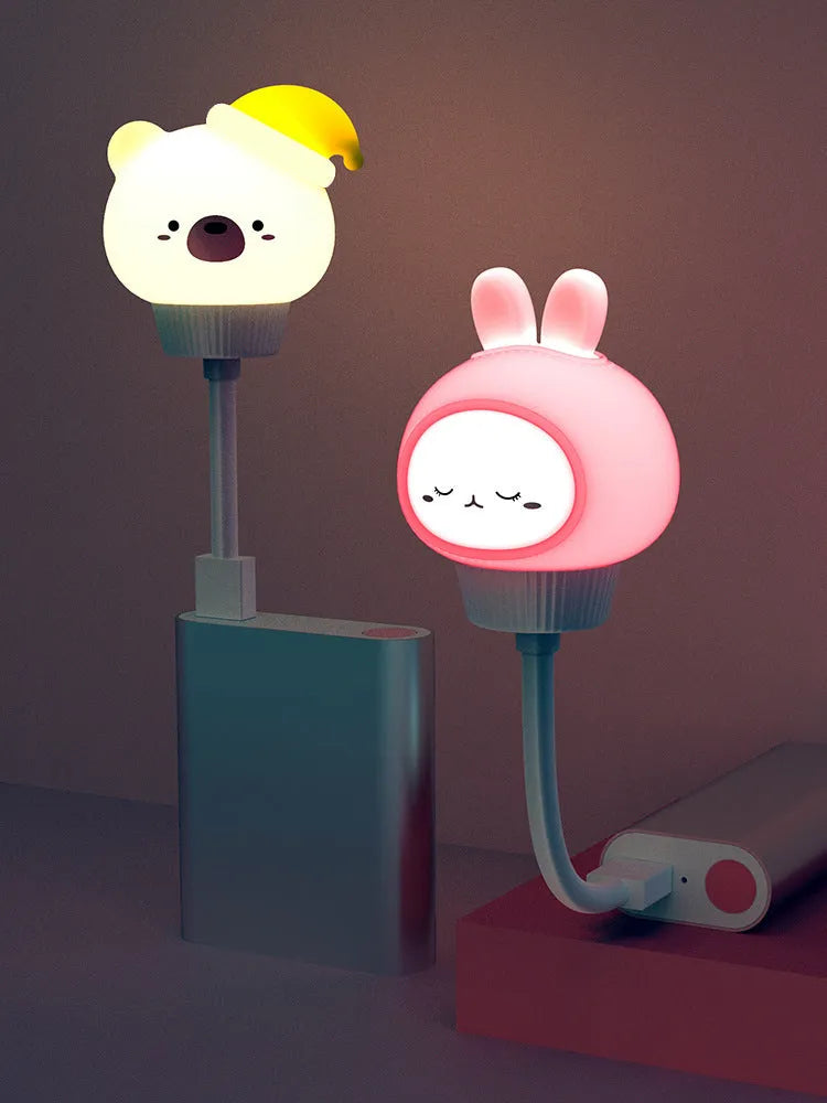 Cartoon bear or rabbit USB LED night light with remote control on a bedside table