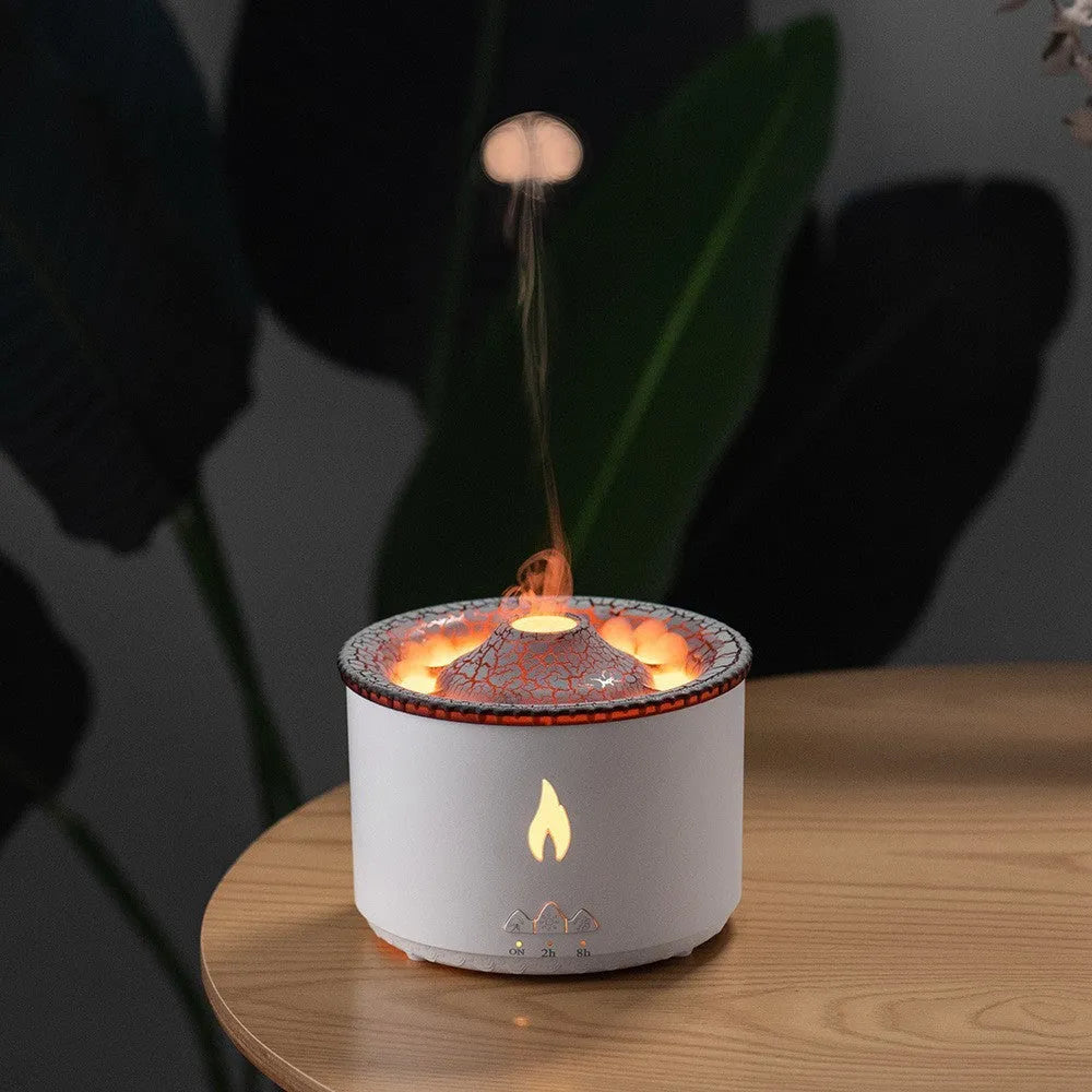 Round two-colour flame spray mist humidifier and aromatherapy diffuser on a table.