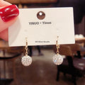 A pair of women's geometric copper earrings with a rose design and small zircon stone accents.