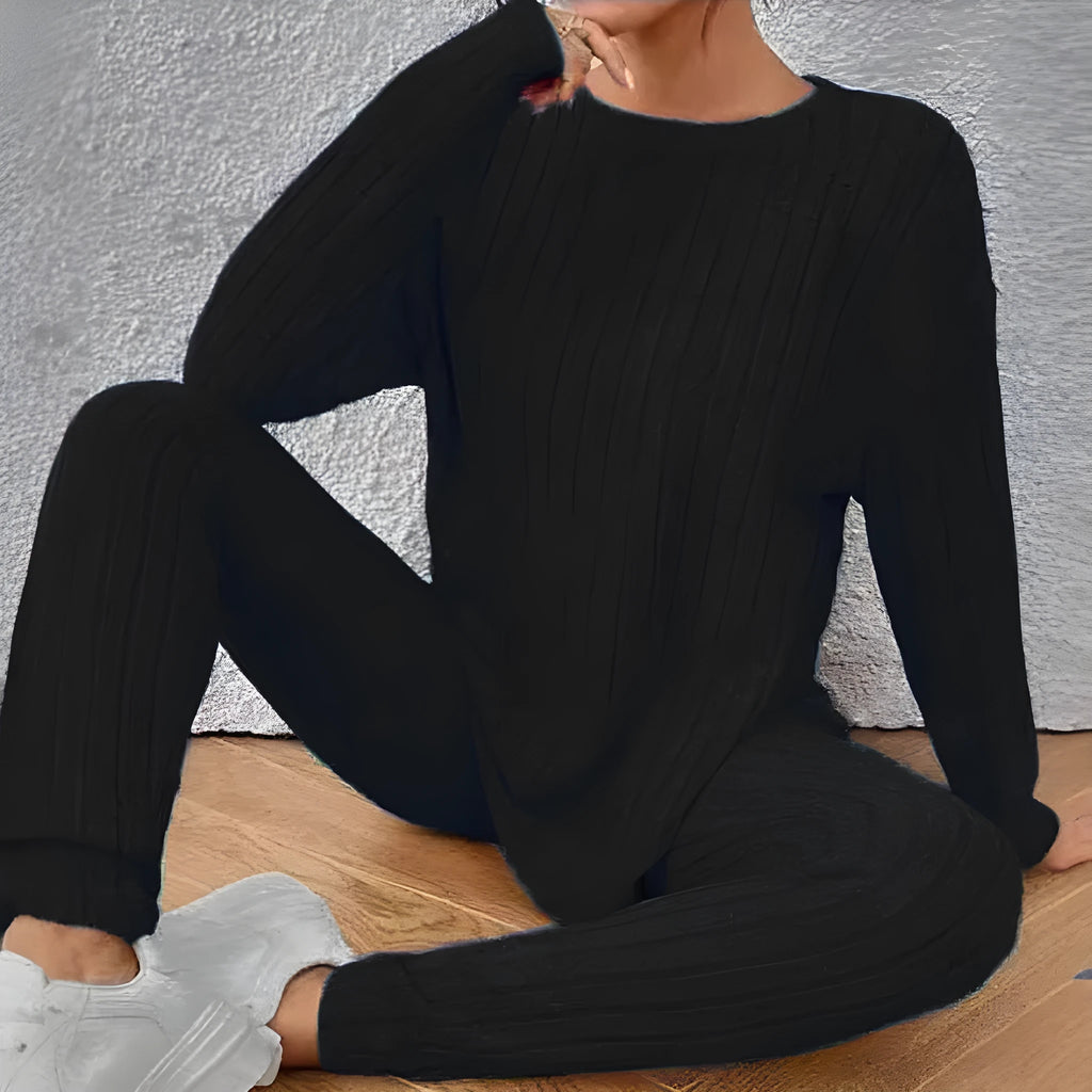 Women's black and blue sunken stripe patterned two-piece polyester homewear set with top and loose-fit pants.