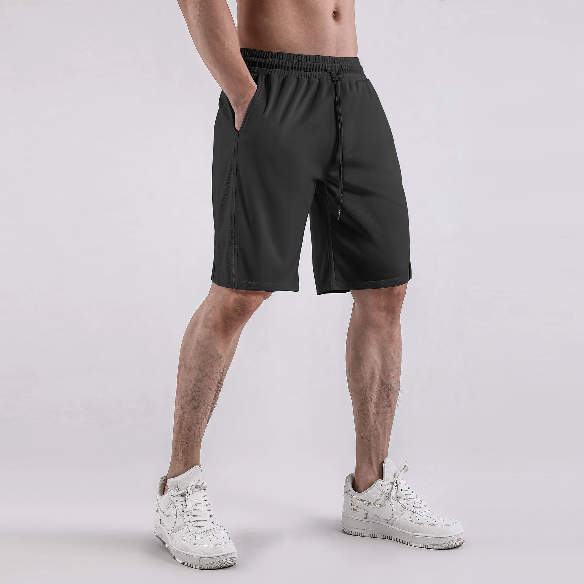 A pair of men's black mesh sports shorts with a loose fit and elasticated waistband.