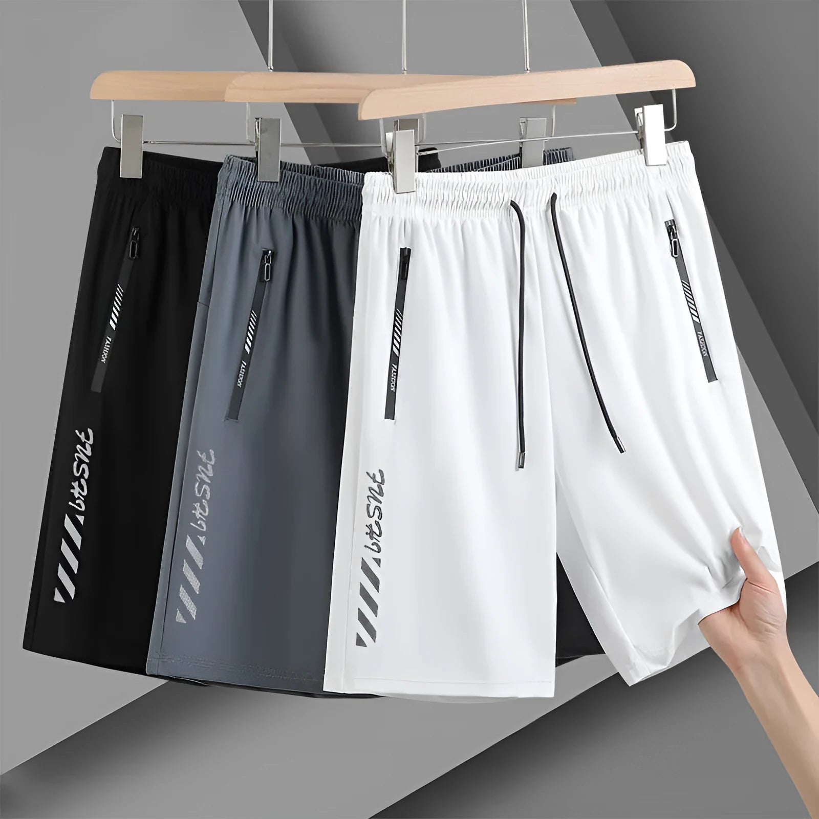Men's black quick-dry nylon sports shorts with loose fit and fifth pants length on hanger