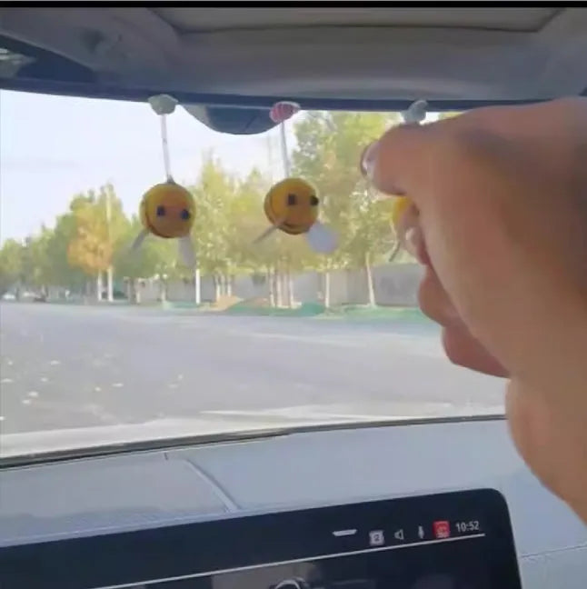 Swing spring bee car decoration made from soft fur ball, showing cartoon bee shape.