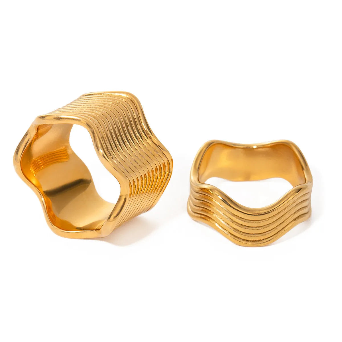 Stainless steel wide band ring with a geometric wave pattern design in an electroplated finish.
