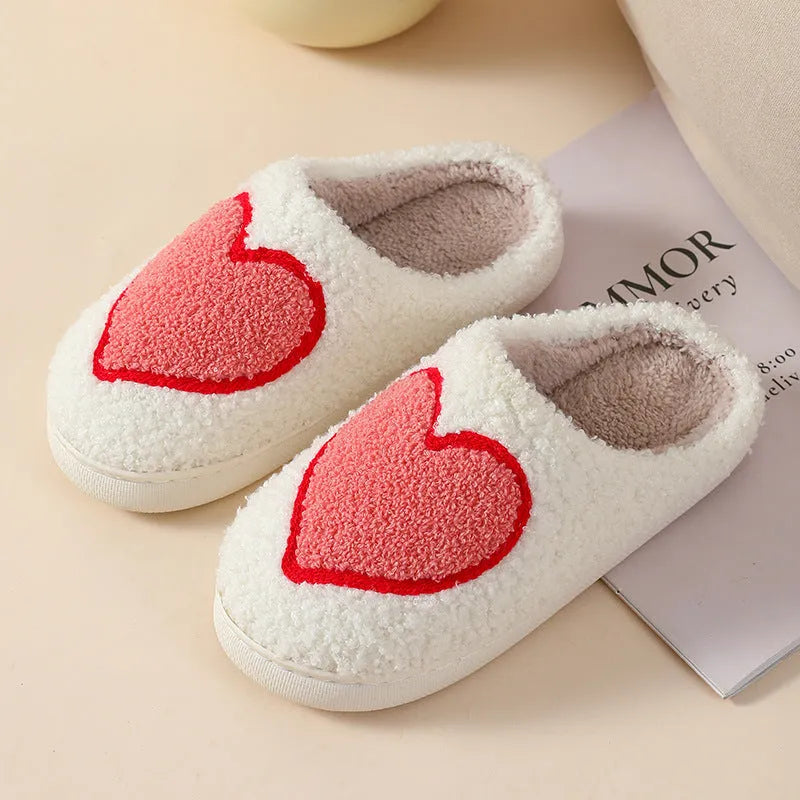 Women's plush cartoon love style home slippers with a non-slip PVC sole.