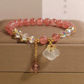 Women's adjustable crystal bracelet with strawberry quartz and white agate beads showing adjustable chain detail