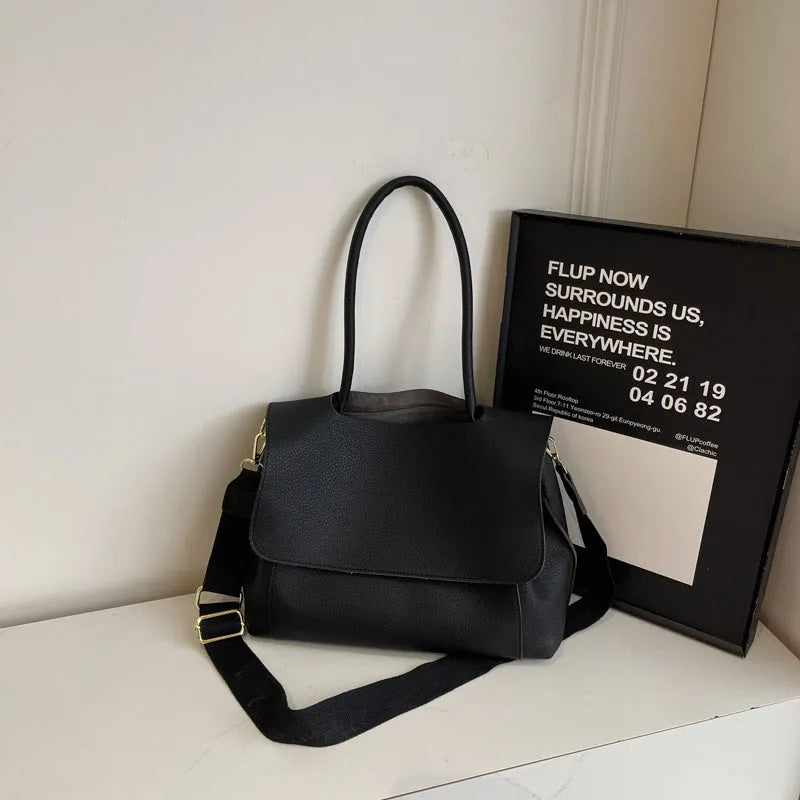 PU leather tote bag in beige with double shoulder strap and visible stitching detail.