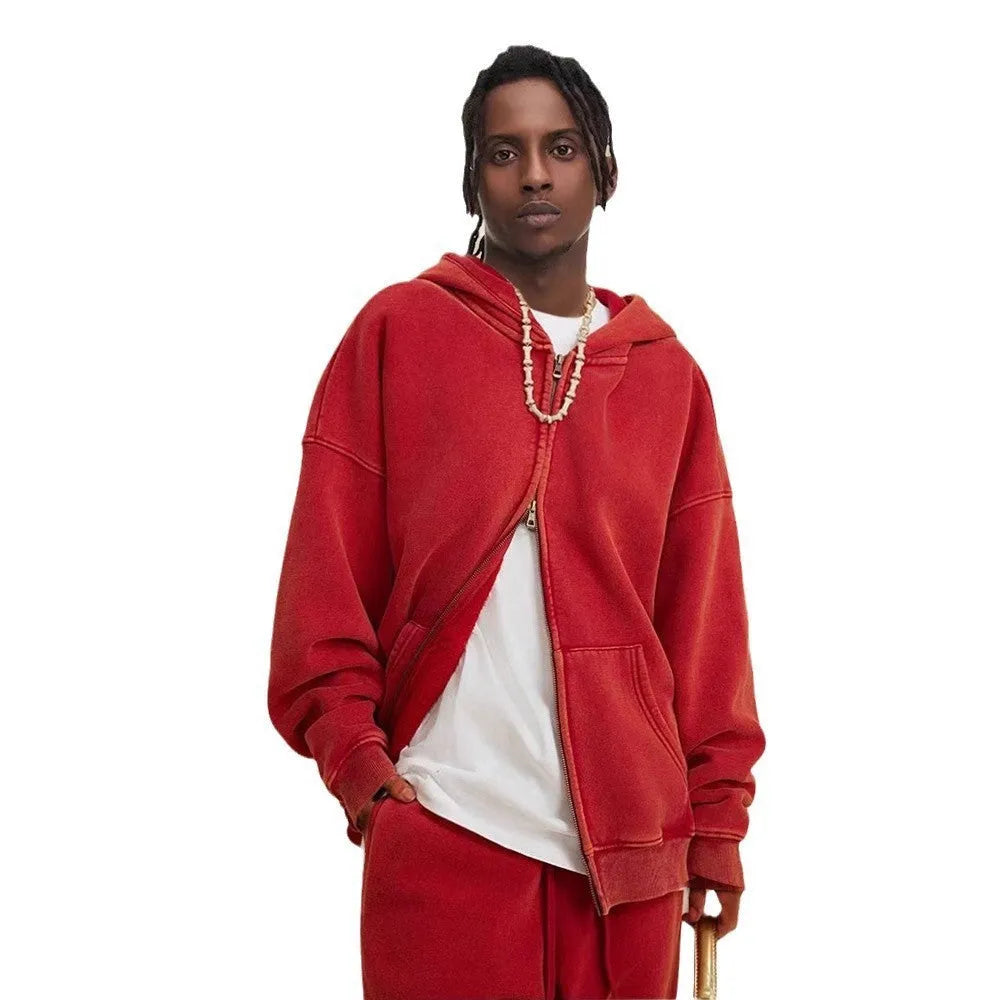 Man wearing a washed black fleece-lined hooded cardigan sweater with a double zip.