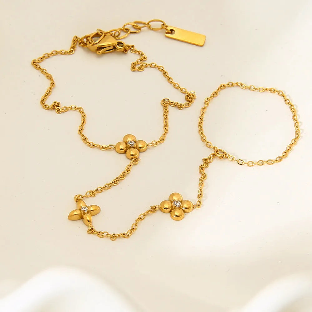 Gold women's stainless steel bracelet with an eight-pointed star and floral geometric design.