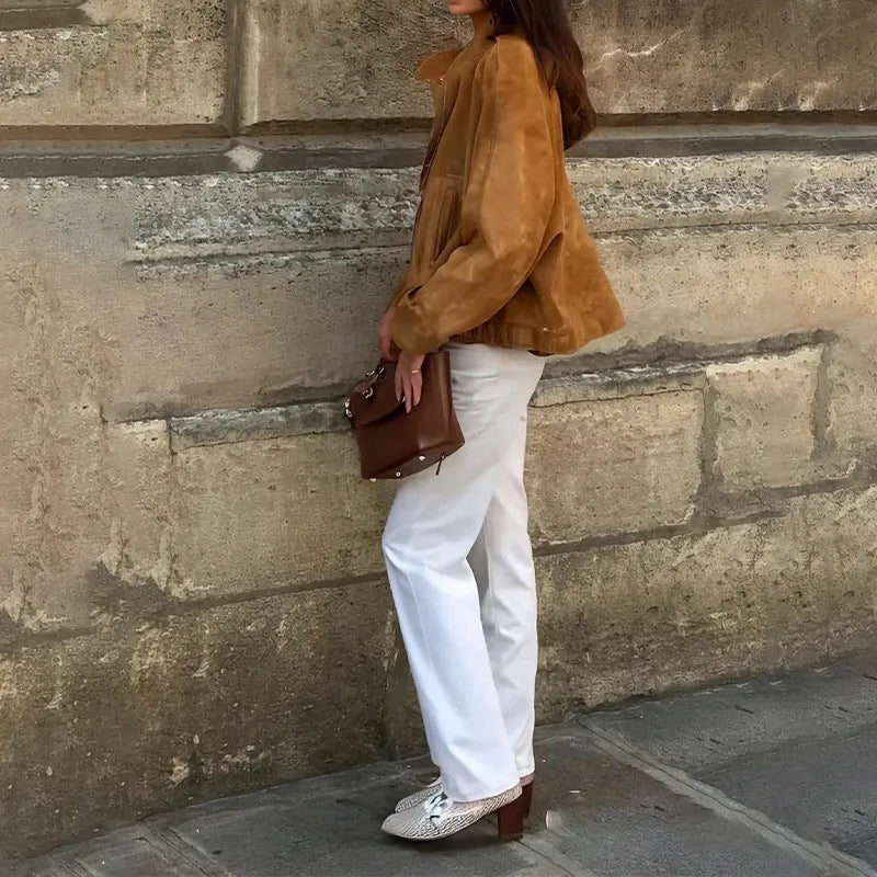 Man wearing a solid colour loose-fit retro style long sleeve polyester jacket.
