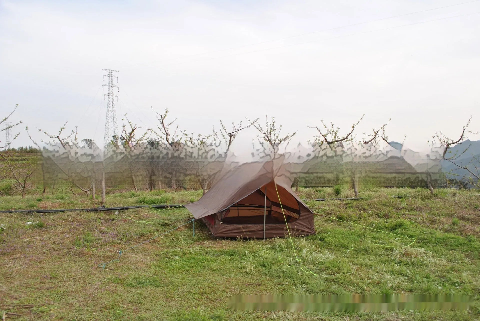 Brown A-line pole-free portable tent with hiking cane support showing interior space for 2-3 people