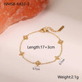 Gold plated stainless steel bracelet with a detailed zircon star pendant on a woman's wrist.