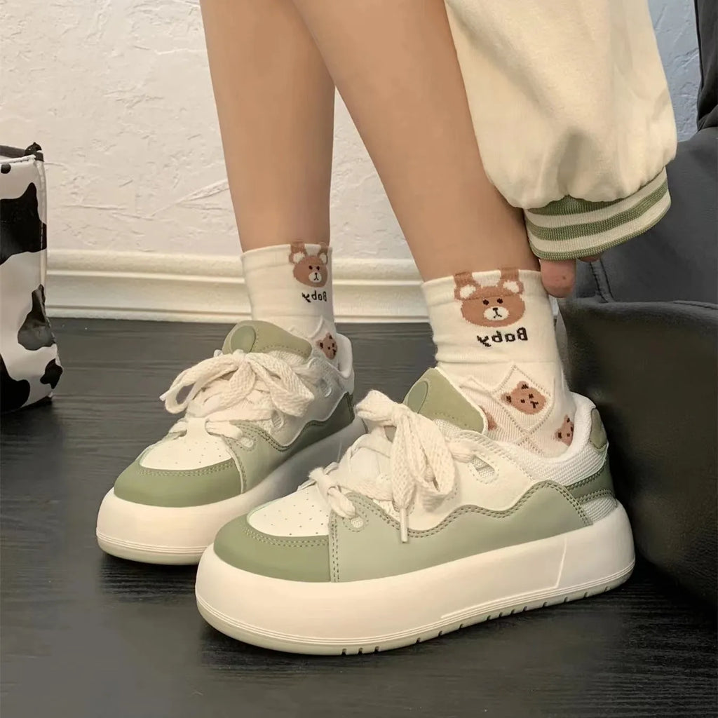 Women's green casual shoes with mesh upper, flat heel, and round toe design