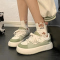 Women's green casual shoes with mesh upper, flat heel, and round toe design