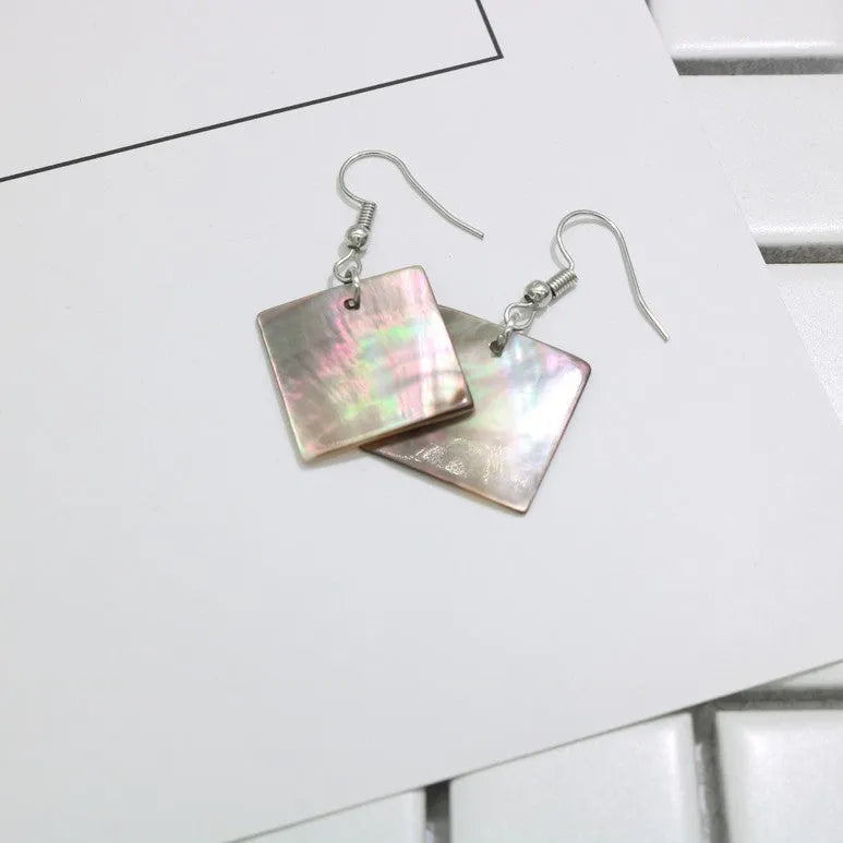Women's geometric shell earrings with rectangular or square panther designs in natural colours