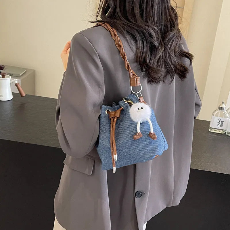 Blue synthetic leather cross body bucket bag with optional hanging ornaments