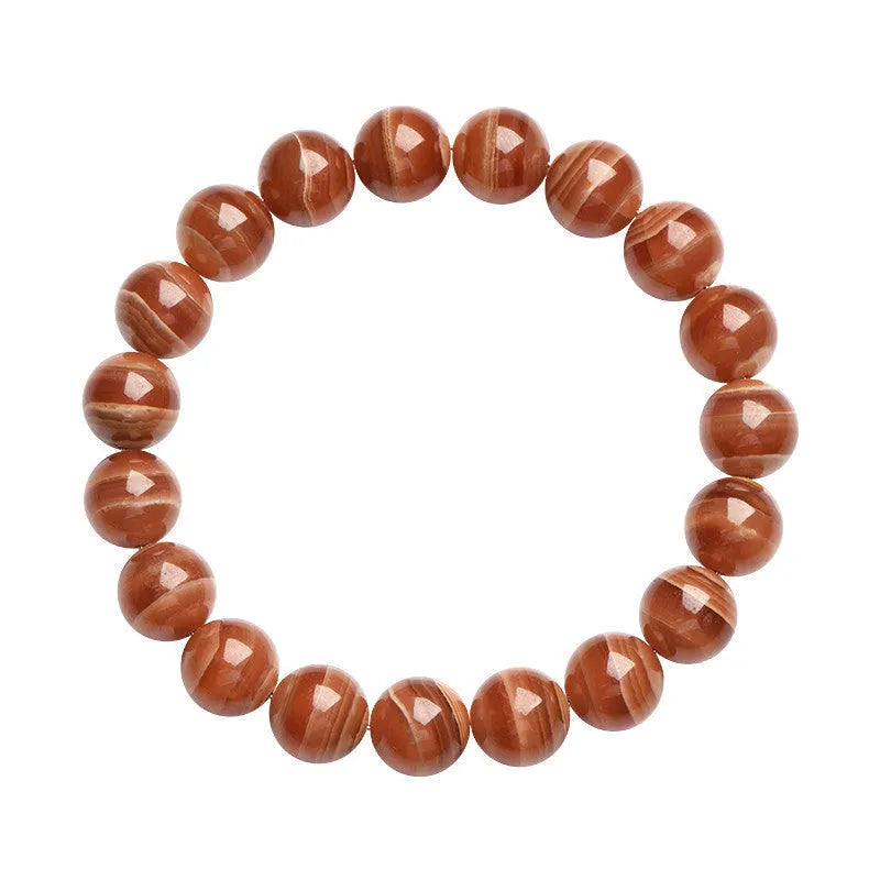Natural rhodochrosite round bead bracelet with ruyi design on wrist.