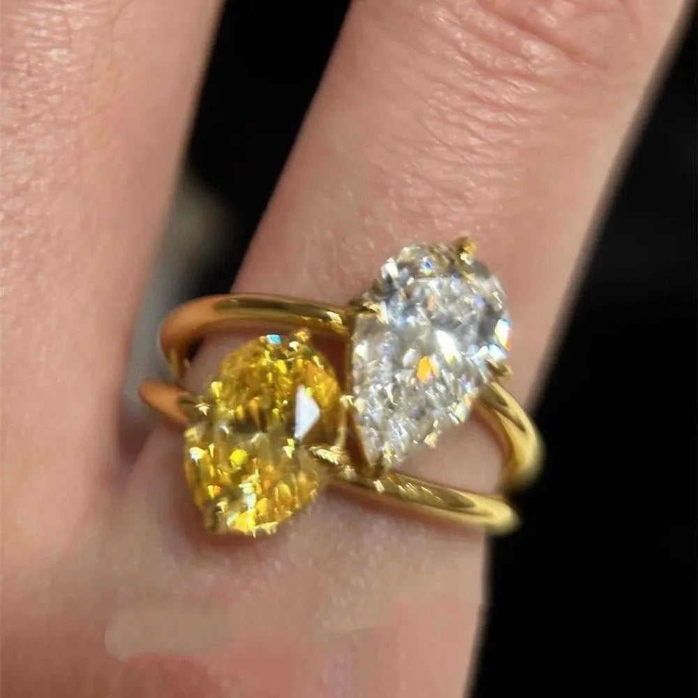 Open geometric ring with water drop shaped zircon stones in contrasting colours