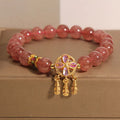 Women's crystal bracelet with strawberry quartz dream catcher ball pendant, original design.