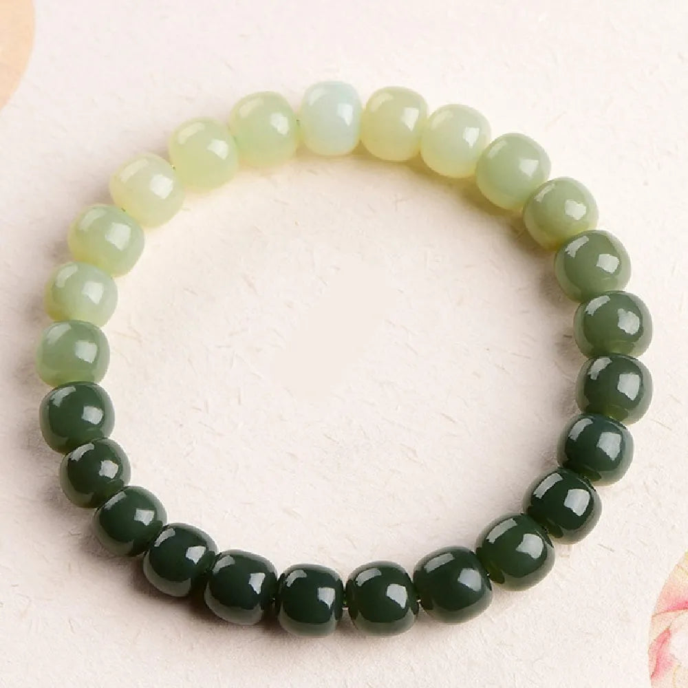 Natural Hetian jade bracelet showing water gradient colour on polished beads.