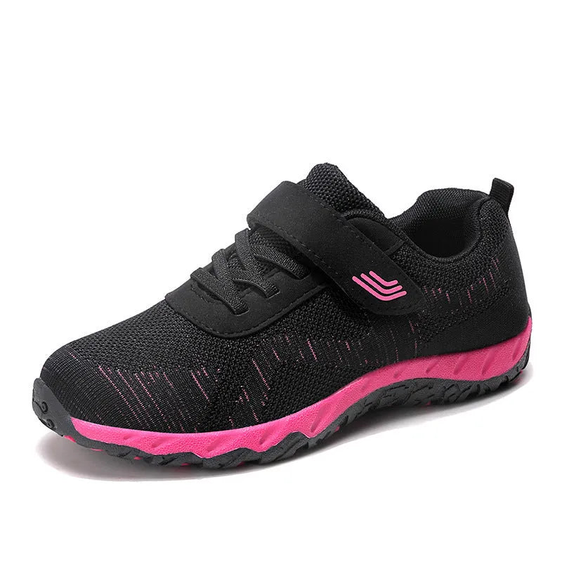 Women's low-top sneakers with Velcro straps and a wedge heel, in a mesh upper and solid colour.