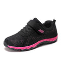 Women's low-top sneakers with Velcro straps and a wedge heel, in a mesh upper and solid colour.