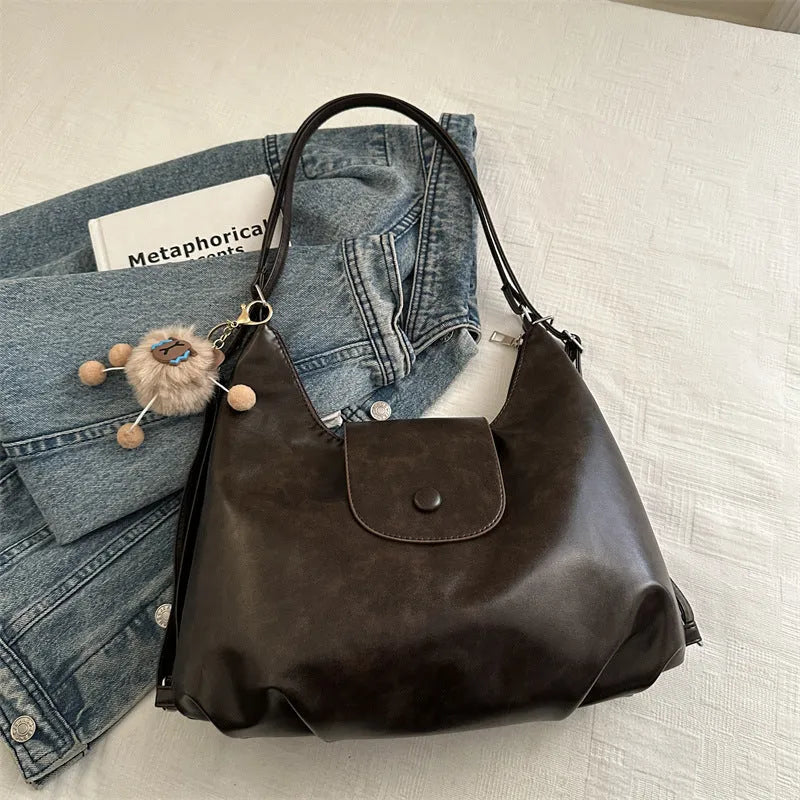Women's PU leather shoulder bag in horizontal square shape with single strap, showing interior mobile phone compartment