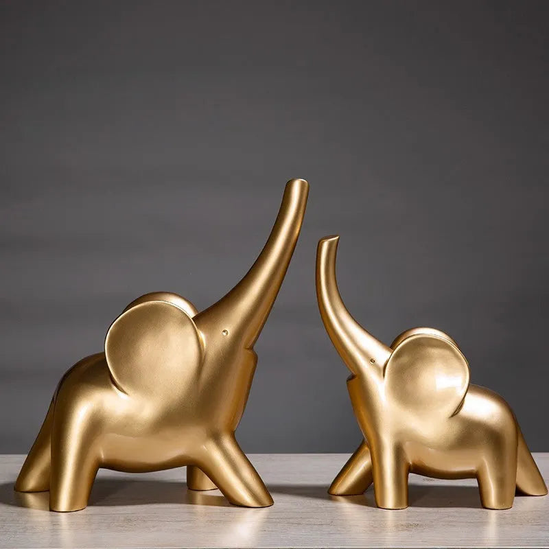 Minimalist rose gold and white resin elephant ornaments on a shelf, showing large and small sizes.