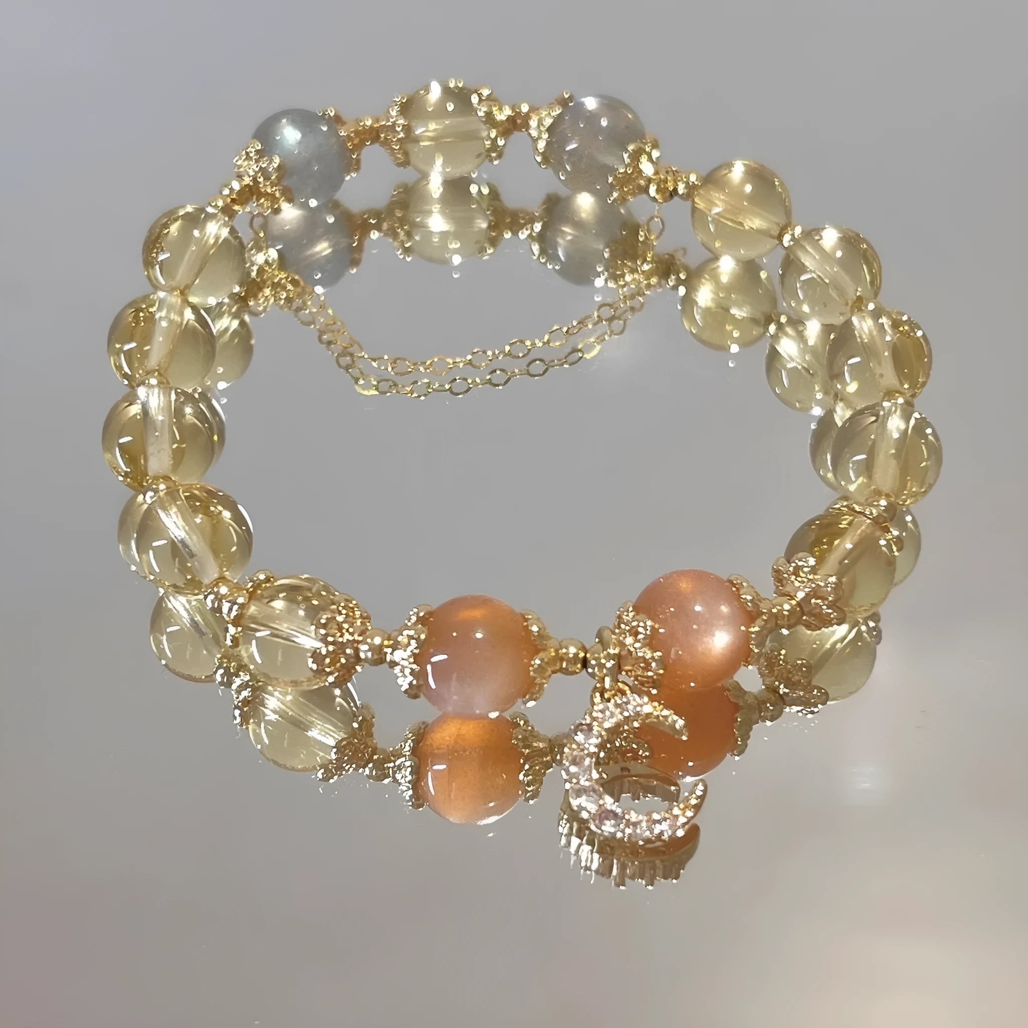 Chinese style crystal bracelet with diamond-shaped stones and gold electroplated finish.