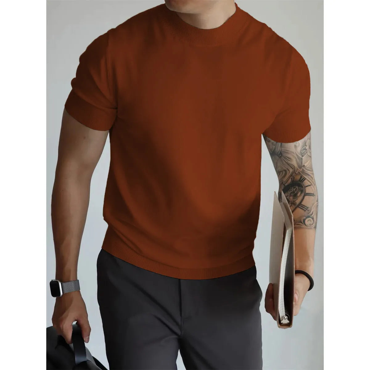 Man wearing a slim-fit solid colour polyester t-shirt, showcasing its lightweight knitwear construction.