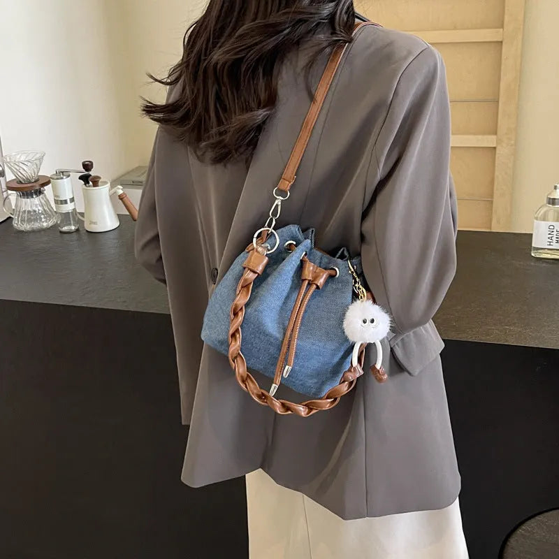 Blue synthetic leather cross body bucket bag with optional hanging ornaments