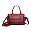Vintage messenger bag in horizontal square shape showing stitching details and shoulder strap