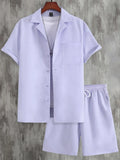 Men's white short sleeve Cuban collar sport shirt and matching shorts laid flat.