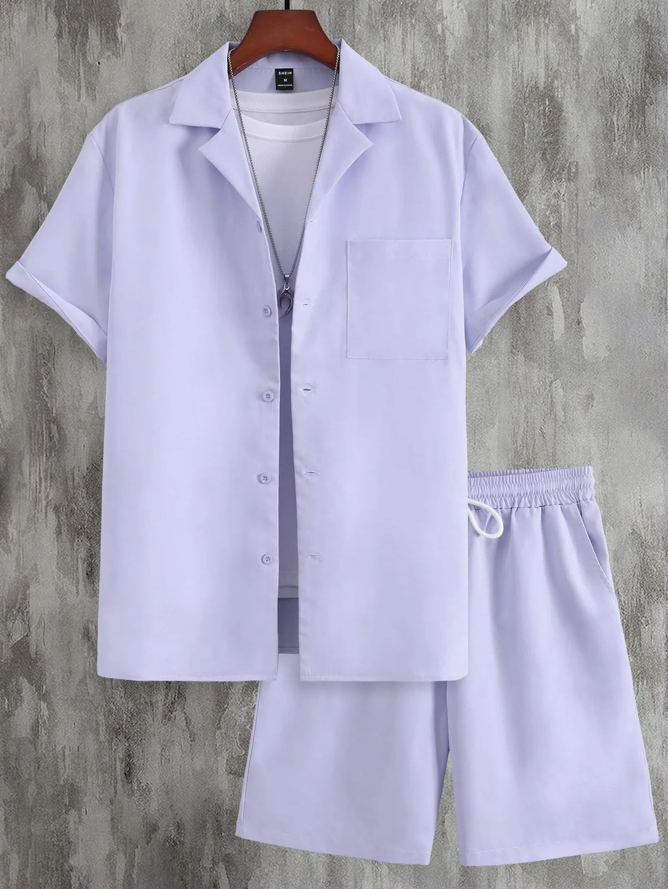Men's white short sleeve Cuban collar sport shirt and matching shorts laid flat.