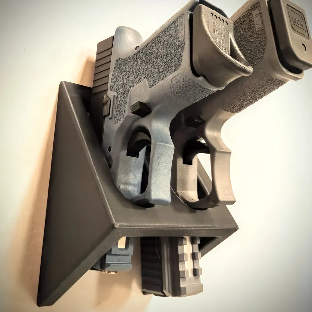 Black plastic pistol stand with punk-style finish for displaying collectible handguns