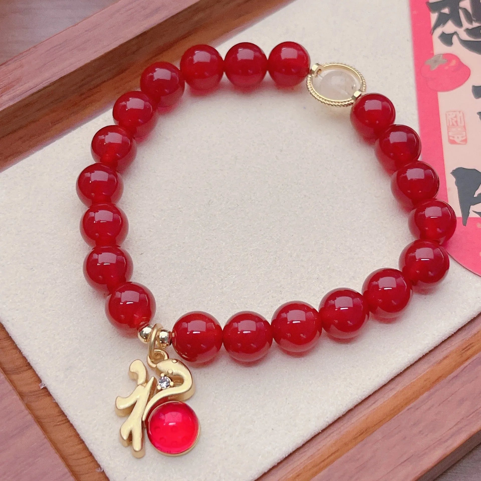 Handmade red agate bracelet with dragon and lucky bag Chinese designs for women.