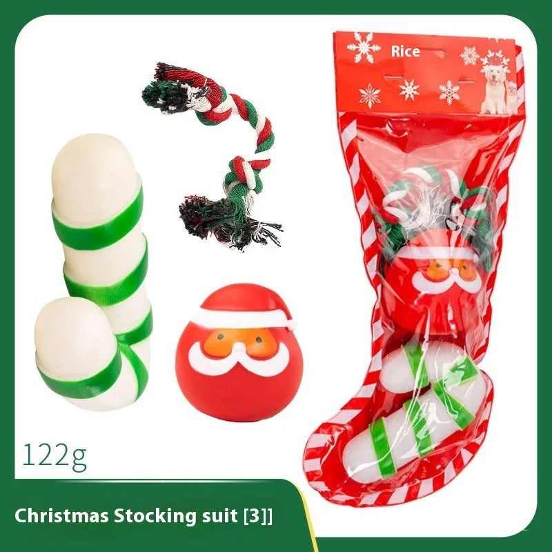 Seven Christmas gift bags containing vinyl dog toys with Santa heads, trees and deer figures