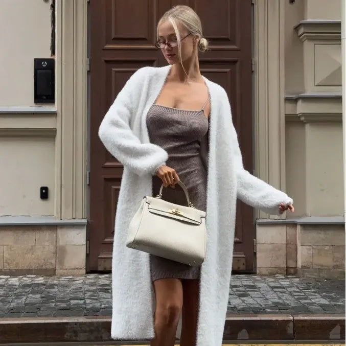 White loose-fit longline cardigan jacket with long sleeves, made of thick knitted polyester fabric.