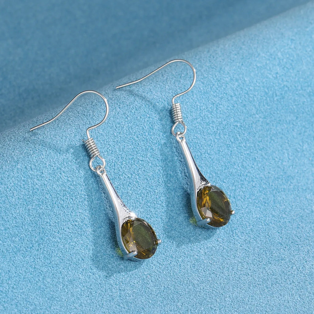 Olive green topaz coloured alloy drop earrings in a water drop shape on a white background.