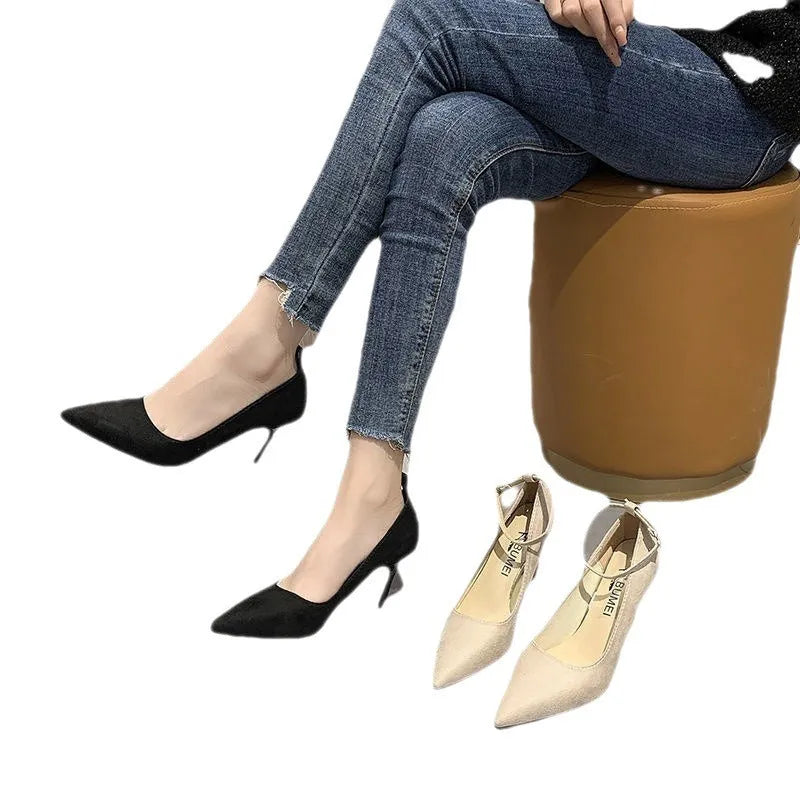 Black women's stiletto heel pump with a buckle detail, shown on a white background.