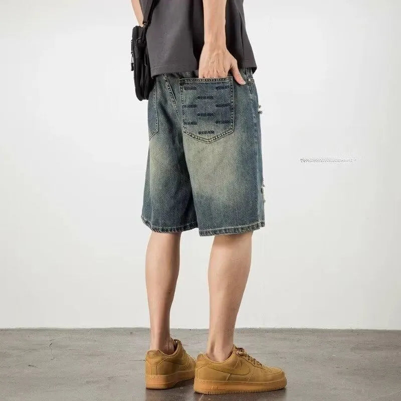 Retro blue denim men's shorts with loose hole details and straight leg.