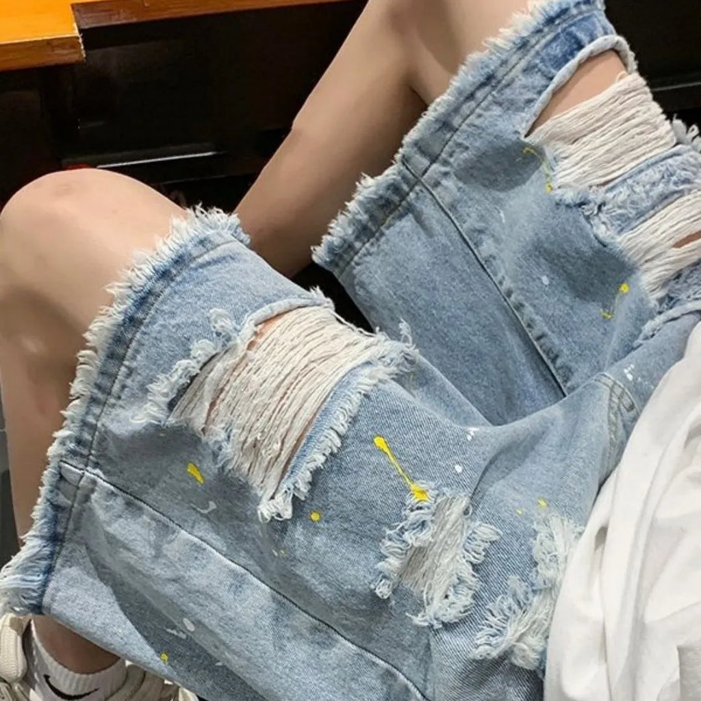 Men's black and light blue loose-fit water-washed denim shorts on a size chart.