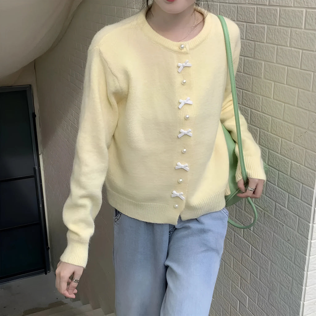 Women's solid colour cardigan sweater with pearl buttons in light blue.
